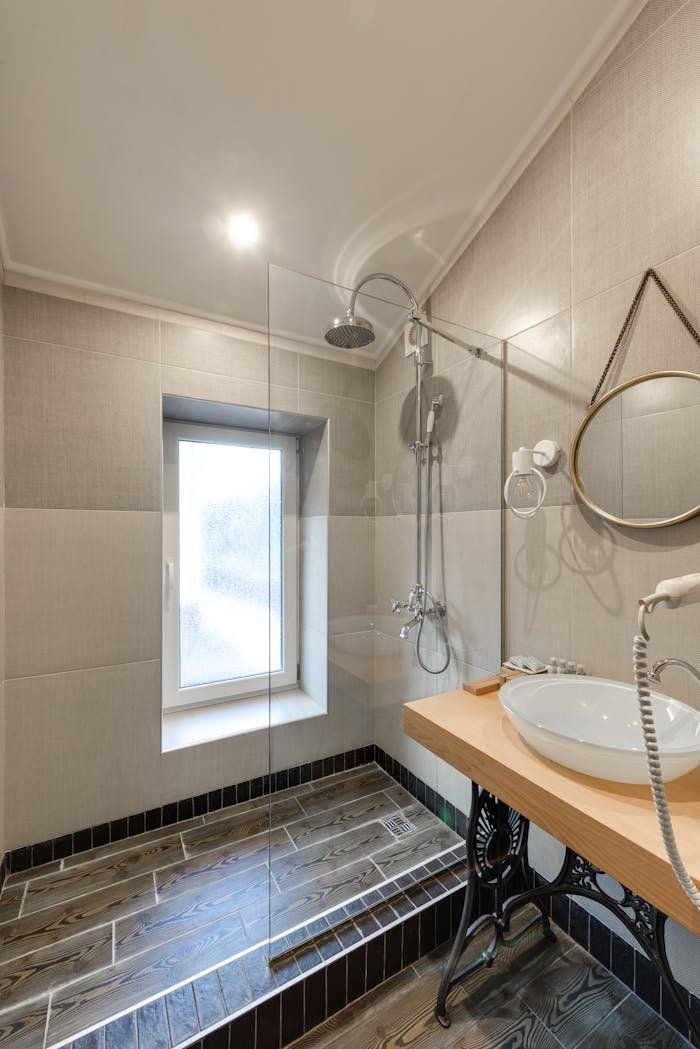 Elegant bathroom design featuring a modern glass shower and stylish fixtures.
